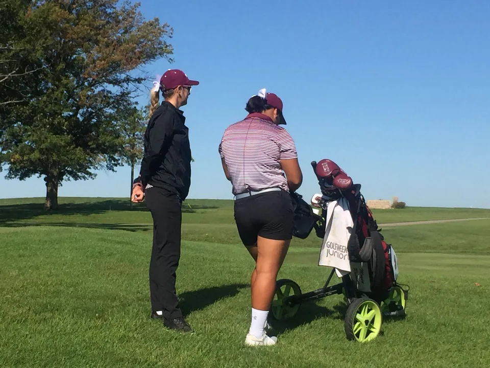 Golfers working together on the course.